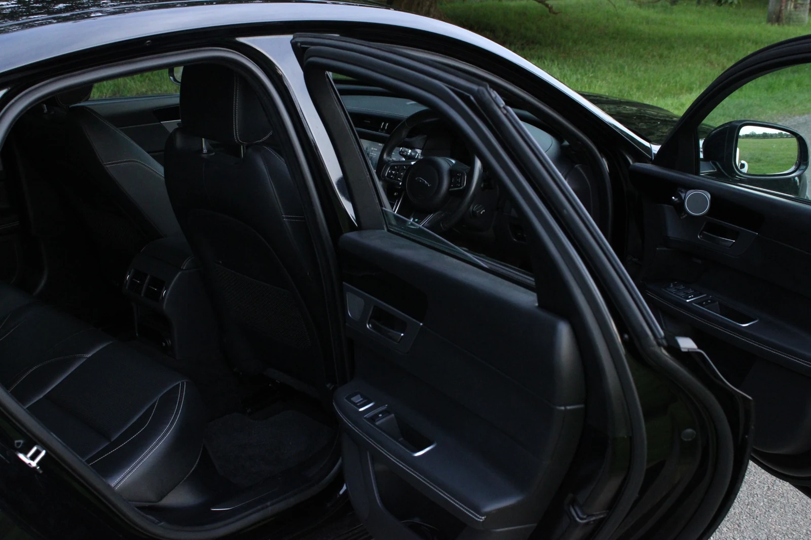 A wide view of the Jaguar cabin through the open doors.